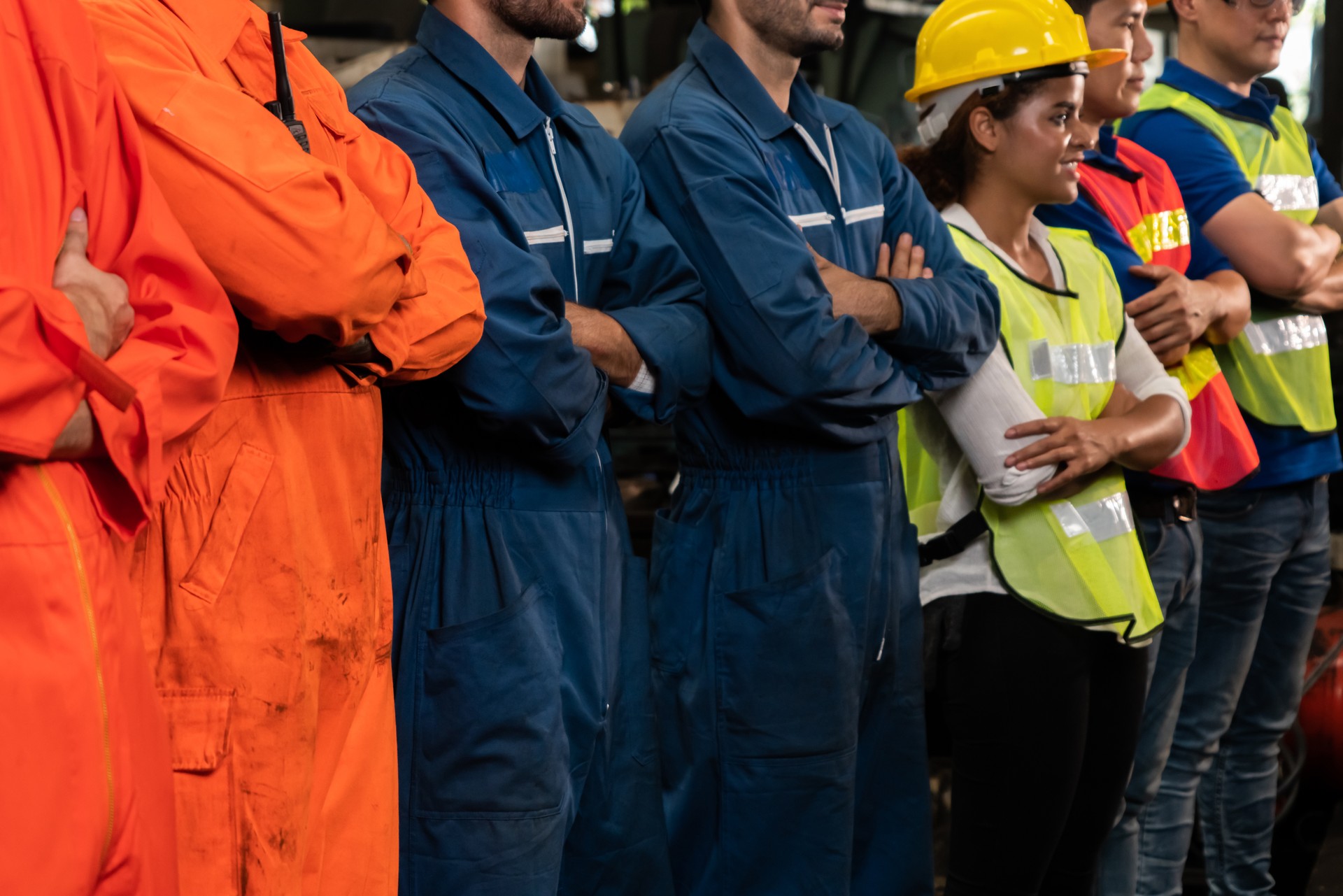 Skillful worker stand together showing teamwork in the factory .